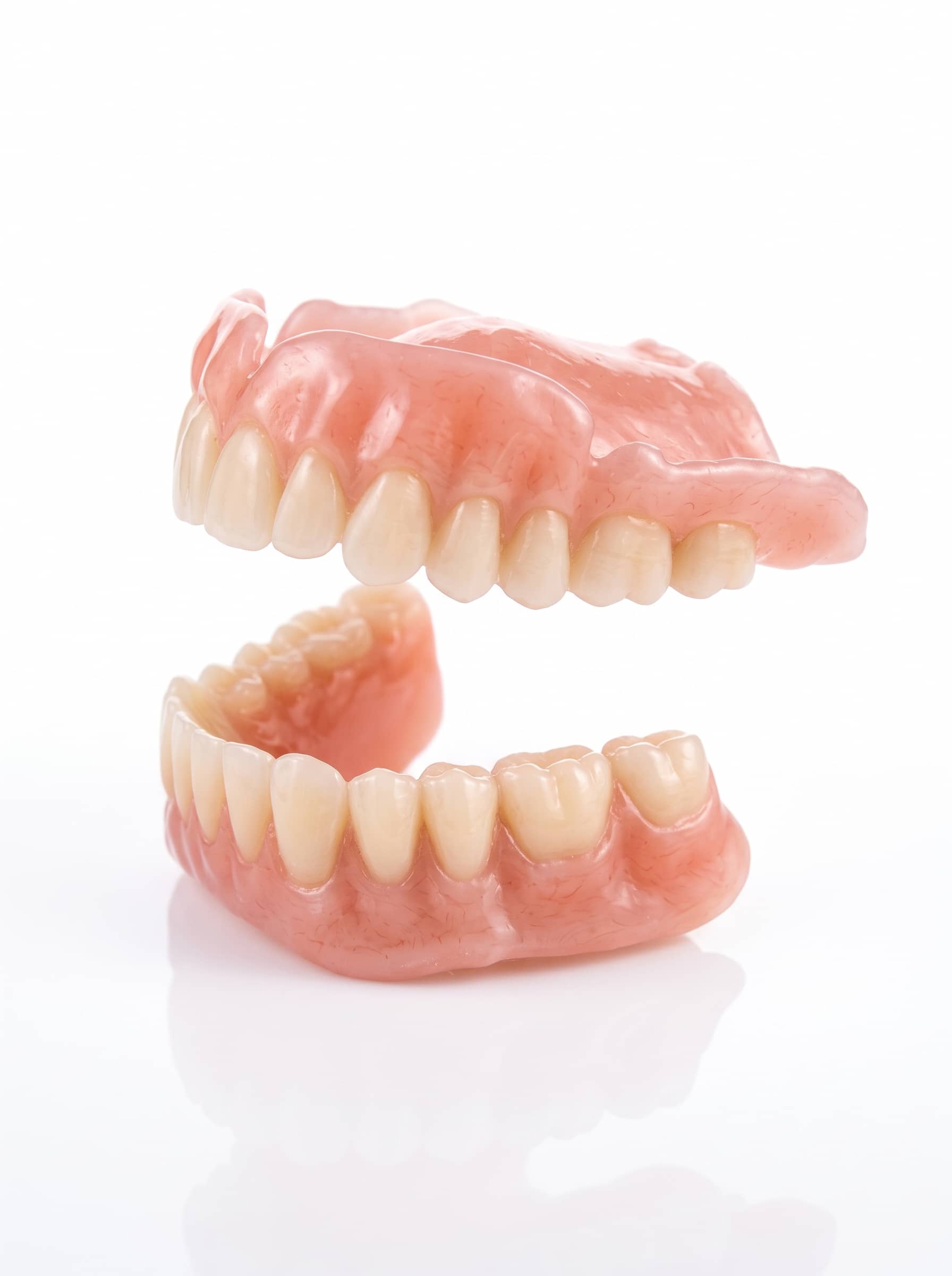 Upper and lower digital dentures on a white background